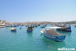 boats-and-luzzu-in-the-blue-water-of-marsaxlokk-harbour